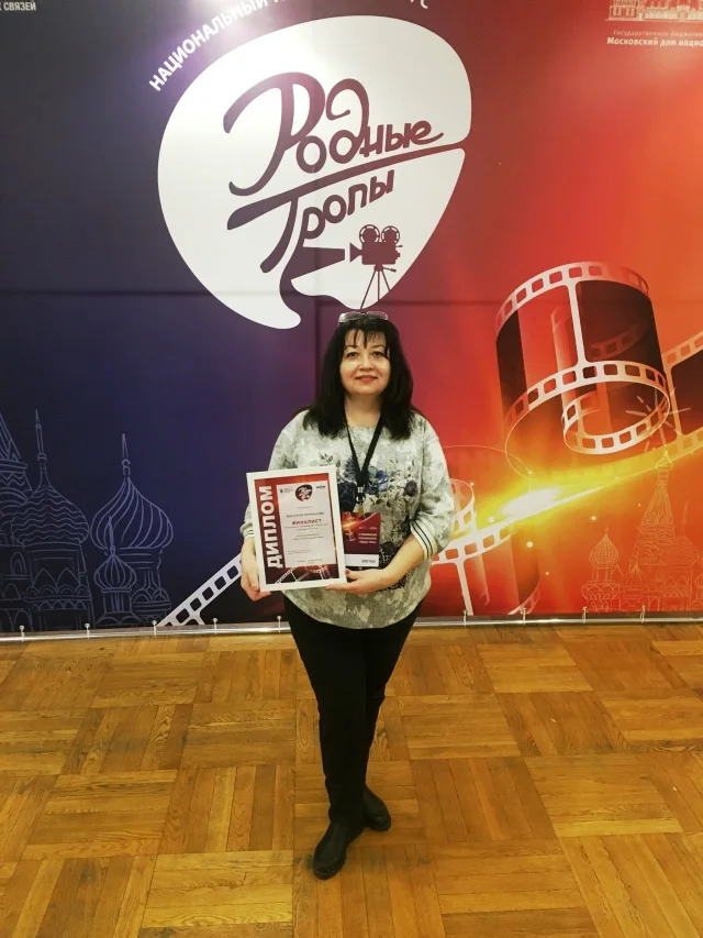 Victoria Garmashova holding her 2022 Native Paths competition diploma